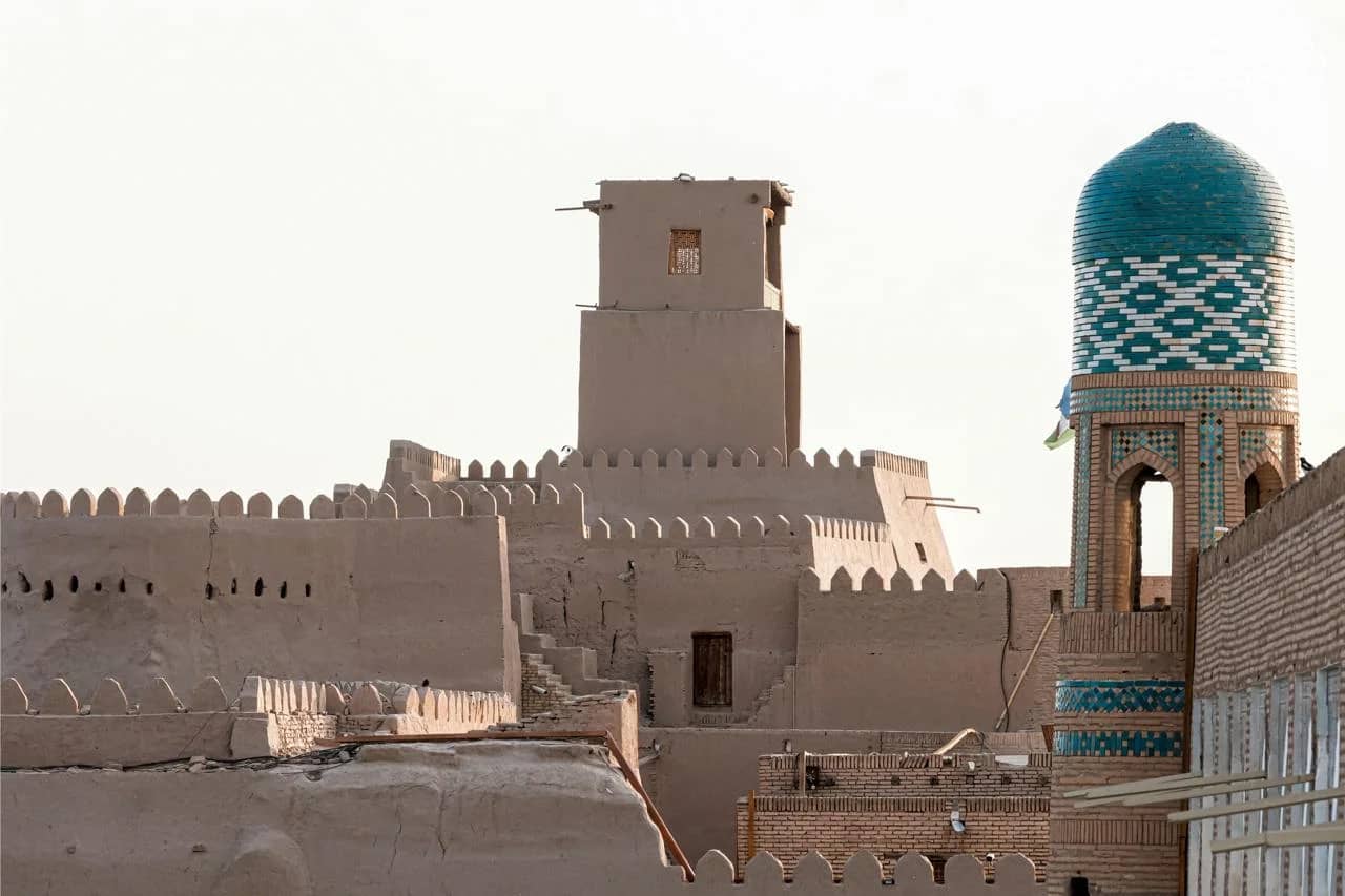 The mud-brick walls of Khiva and a turquoise-tiled minaret